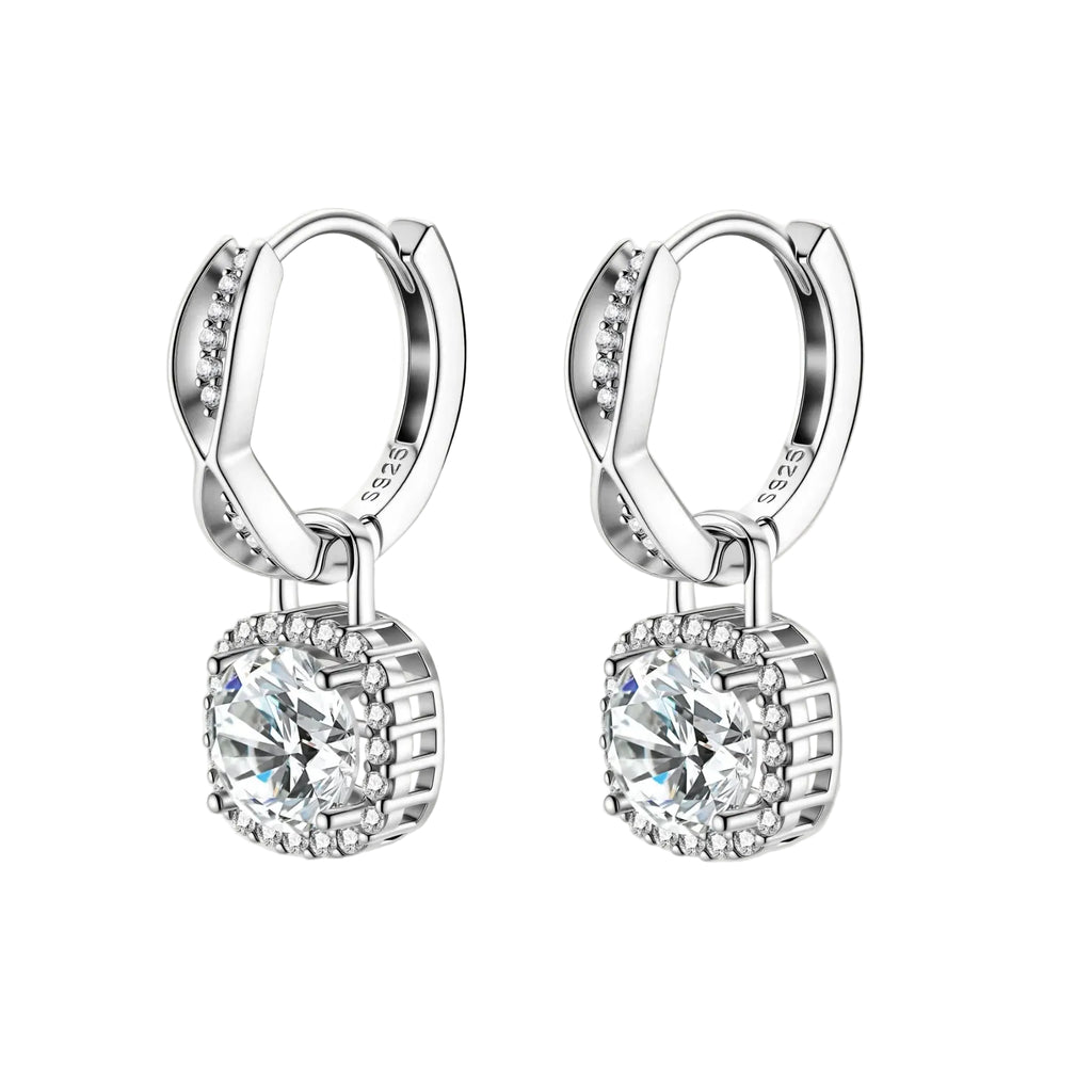 Sterling silver twisted hoop earrings with round moissanite stones in halo settings against neutral background.