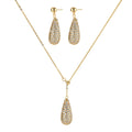 Gold-plated teardrop necklace and earrings covered in AAA cubic zirconia crystals on cream background.