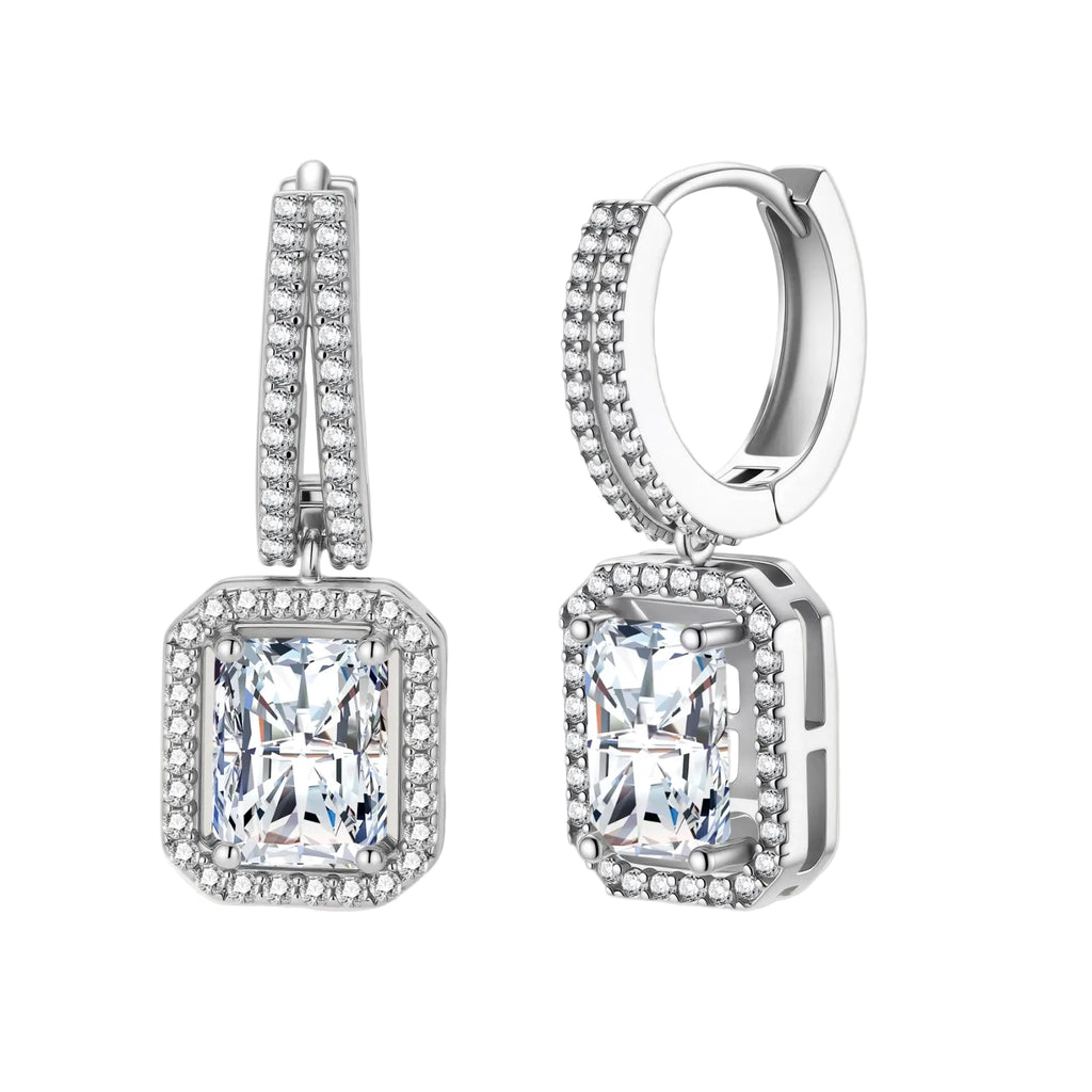 Sterling silver huggie hoops with emerald-cut moissanite drops featuring pavé-set crystals on white background.