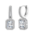 Sterling silver huggie hoops with emerald-cut moissanite drops featuring pavé-set crystals on white background.