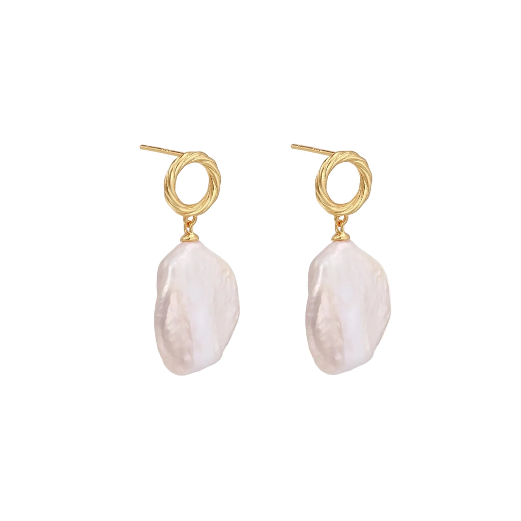 18K gold vermeil twisted circle studs with organic white baroque pearl drops on cream background