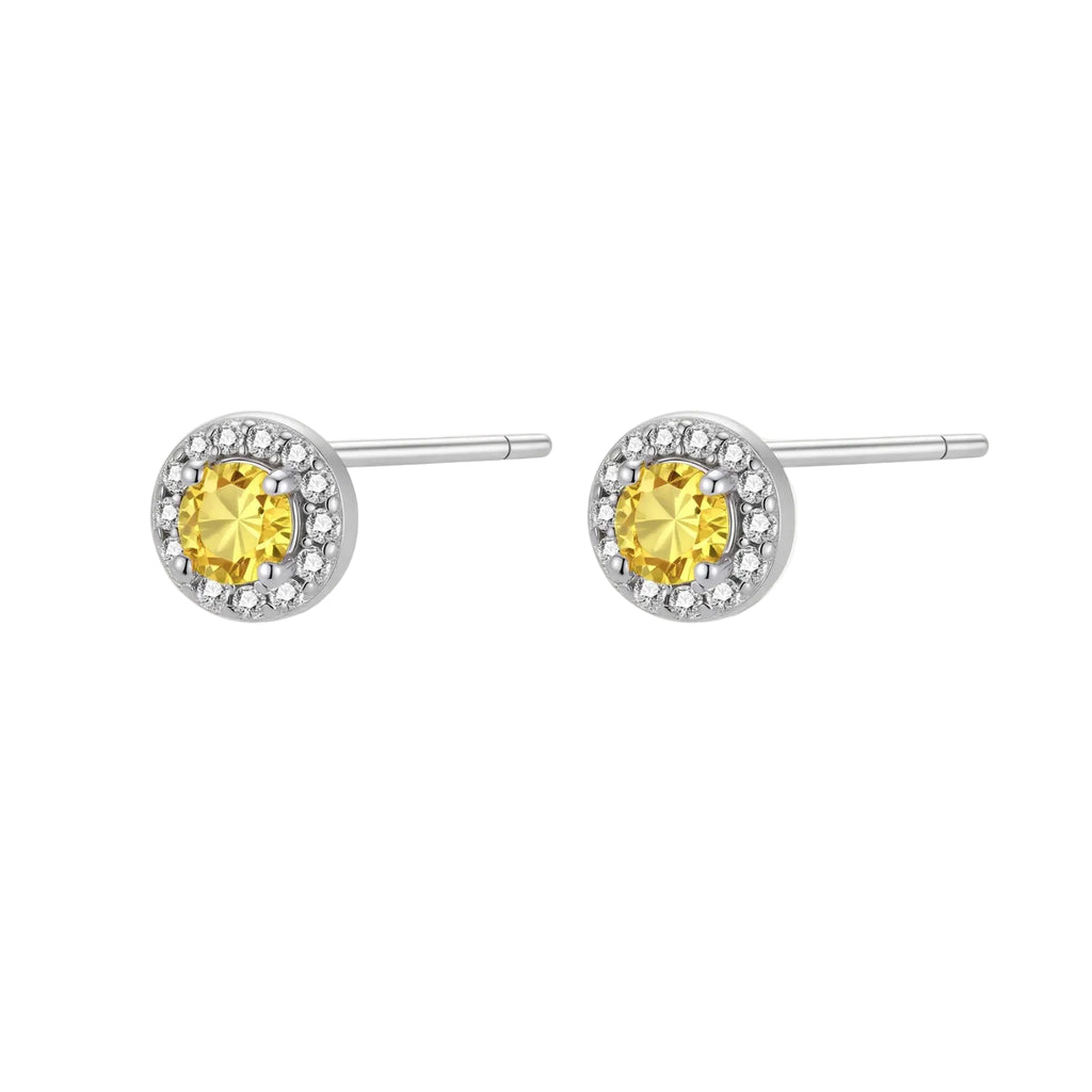 Dainty sterling silver stud earrings with yellow moissanite center stones surrounded by white halo stones