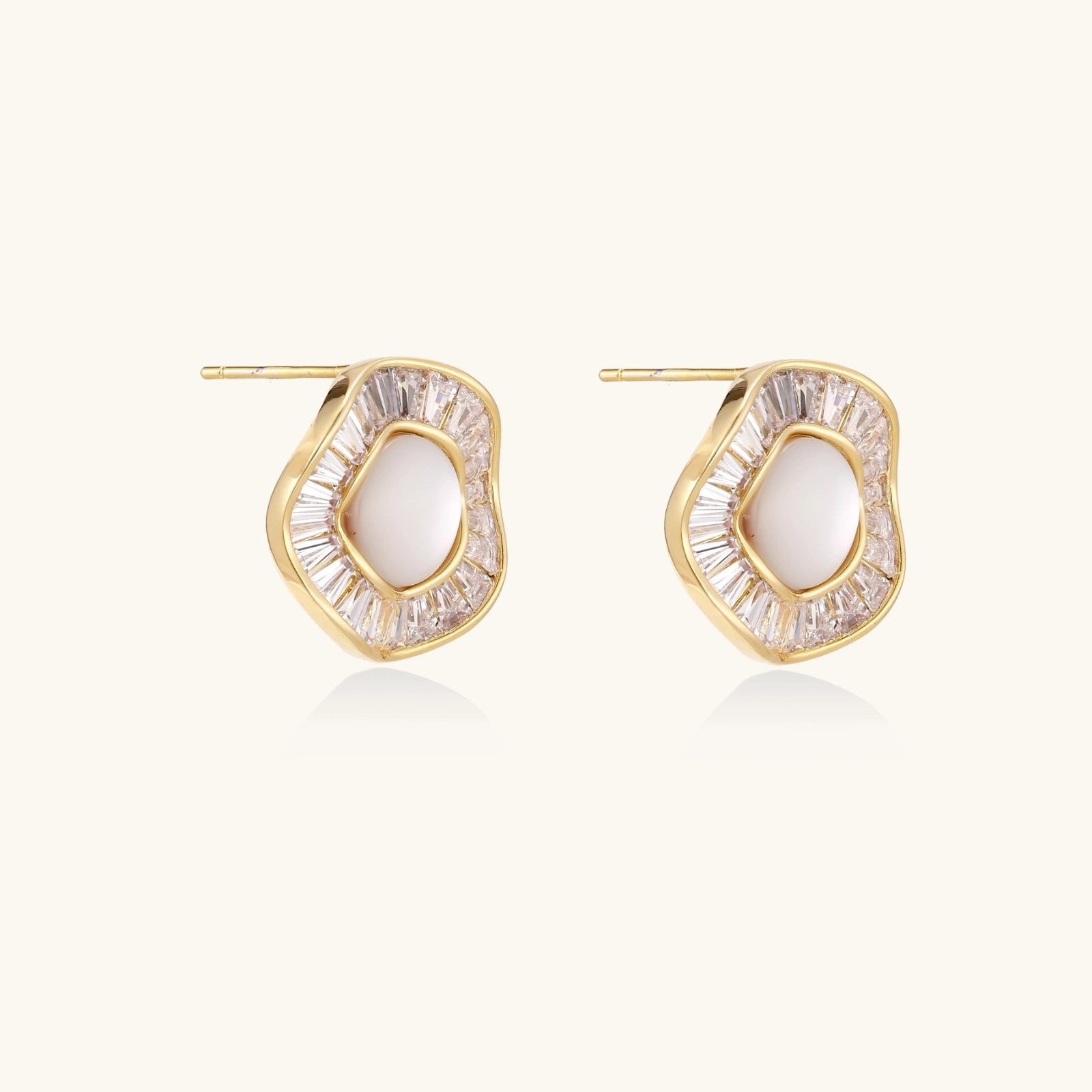 Round 14K gold-plated stud earrings with a mother of pearl center surrounded by baguette-cut crystals, 16mm.