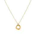 Delicate gold-plated necklace with three interlocking circle rings forming a minimalist knot pendant on cream background
