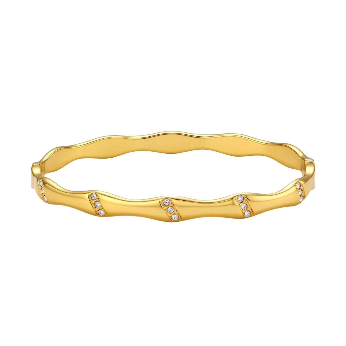 Gold-toned wavy bangle with bamboo-style segments and CZ crystal clusters on cream background. 18K plated stainless steel.